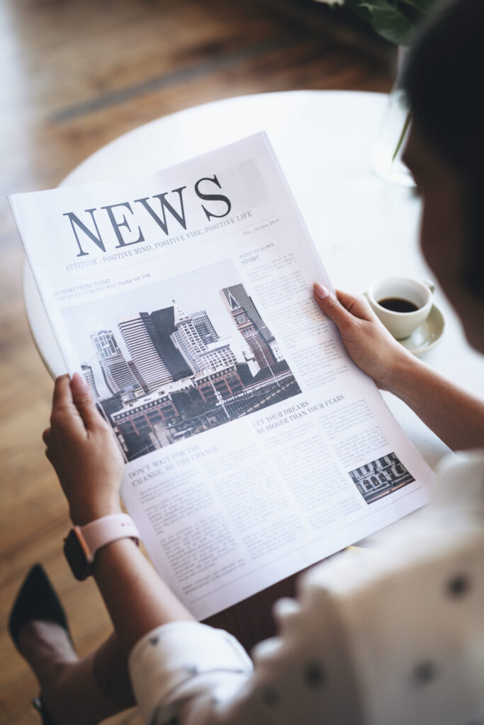 woman reading a newspaper
