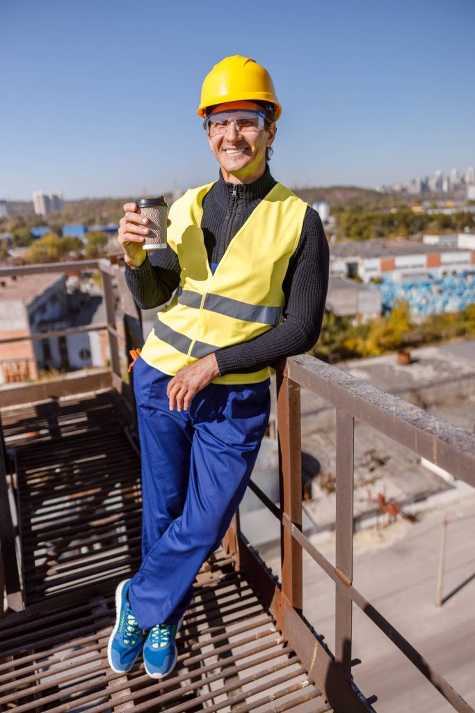joyful male engineer with cup of coffee standing o 2023 11 27 05 26 28 utc